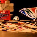 A vibrant arrangement of games, including cards, dice, and sticks, on a table.